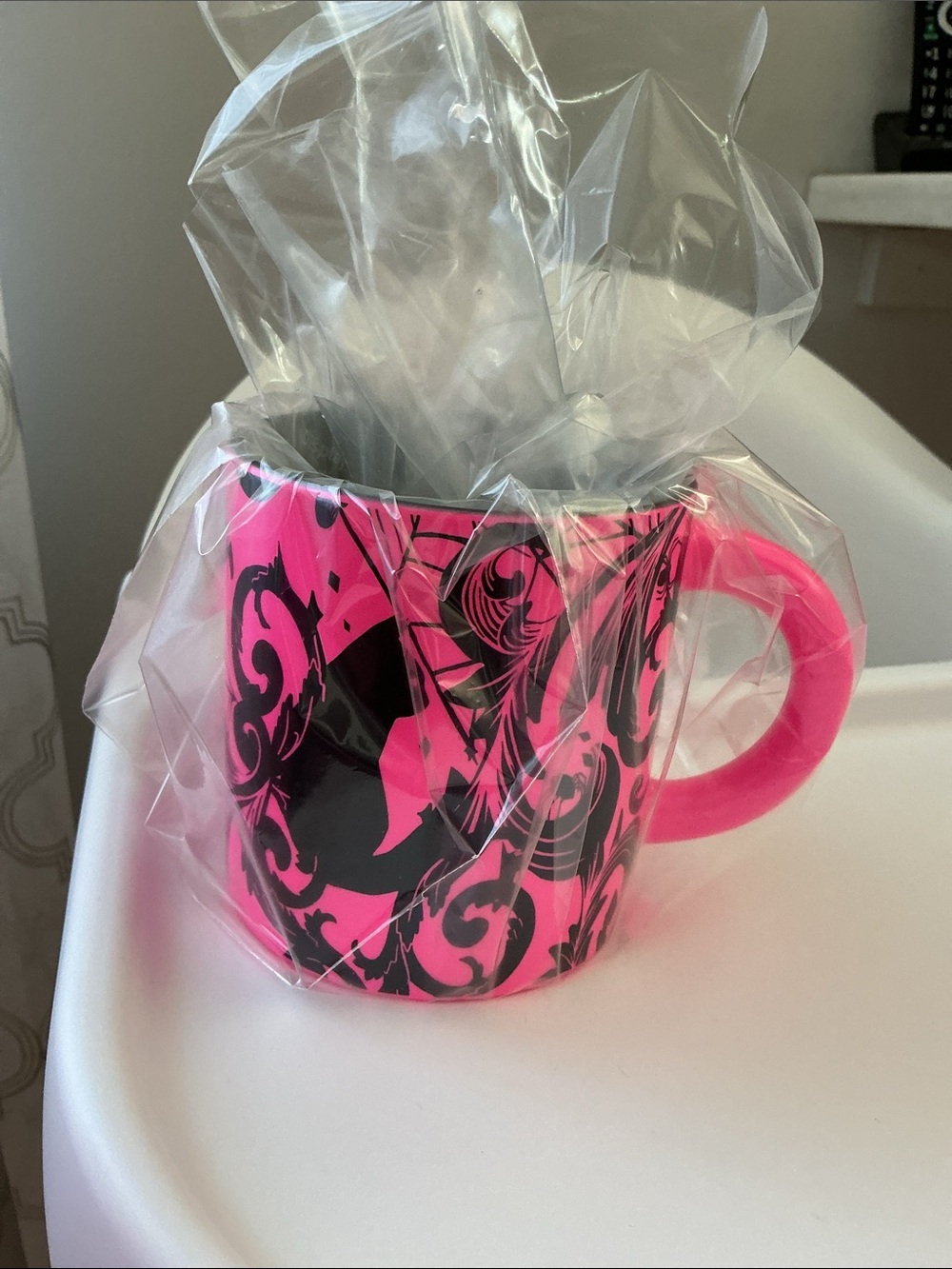 Starbucks 2021 Halloween collection mug featuring a neon pink color with black.